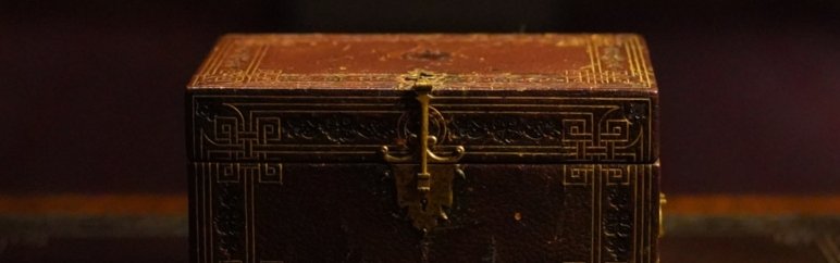 Close up of antique, wooden box with lock.
