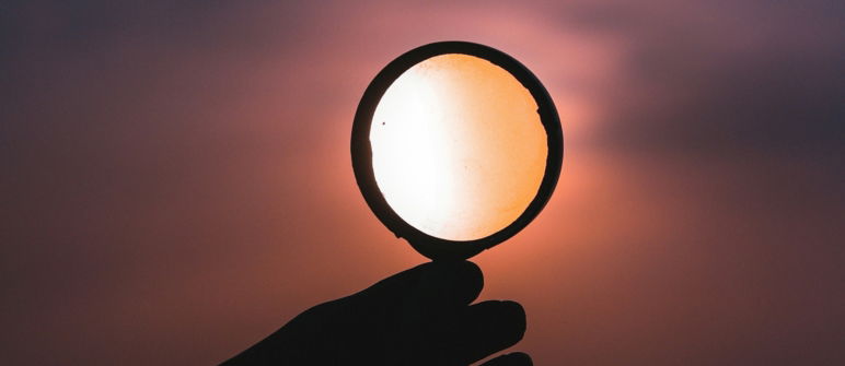 closeup of hand holding a magnifying glass